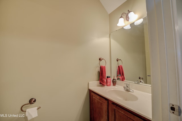 bathroom with vanity and vaulted ceiling