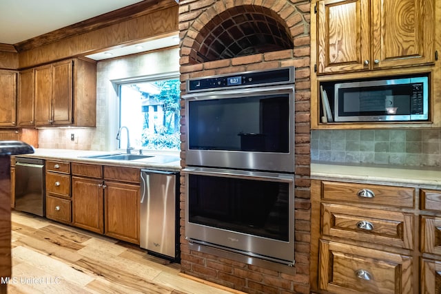 6147 Wirtz Rd, Flowood, MS 39232 - kitchen with stainless steel appliances, tasteful backsplash, light countertops, and brown cabinets