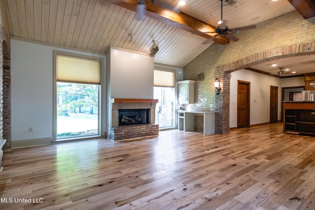 6147 Wirtz Rd, Flowood, MS 39232 - unfurnished living room with a brick fireplace, ceiling fan, wood finished floors, brick wall, and a wooden ceiling with exposed beams