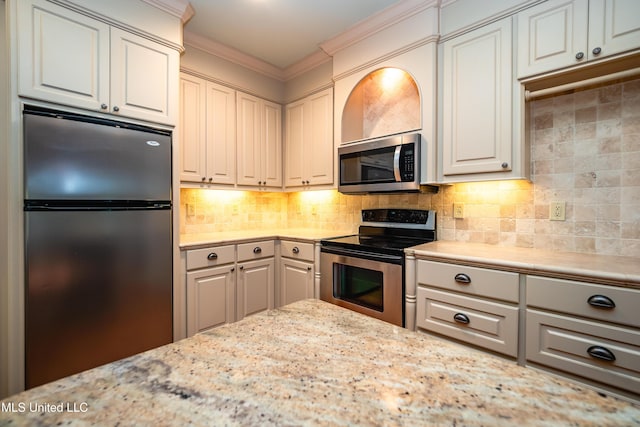 6147 Wirtz Rd, Flowood, MS 39232 - kitchen with appliances with stainless steel finishes, ornamental molding, backsplash, and light stone countertops
