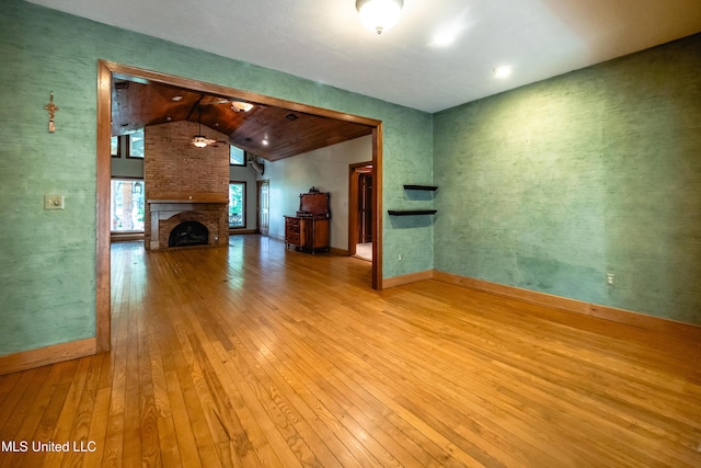 6147 Wirtz Rd, Flowood, MS 39232 - unfurnished living room with lofted ceiling, hardwood / wood-style flooring, and a fireplace