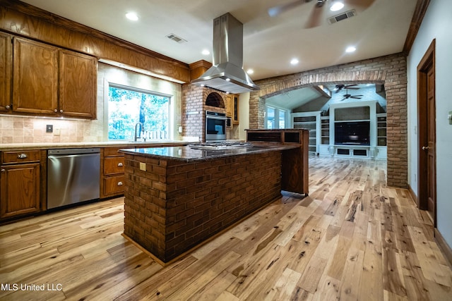 6147 Wirtz Rd, Flowood, MS 39232 - kitchen with a ceiling fan, stainless steel appliances, island exhaust hood, light wood-style flooring, and open floor plan