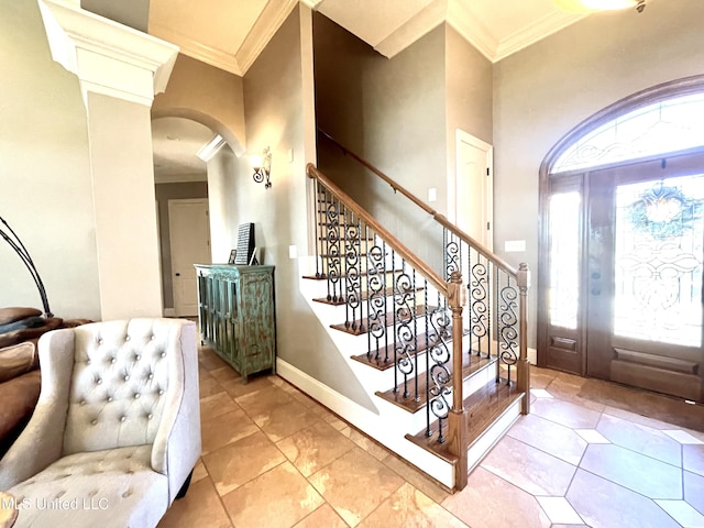 tiled entrance foyer featuring crown molding