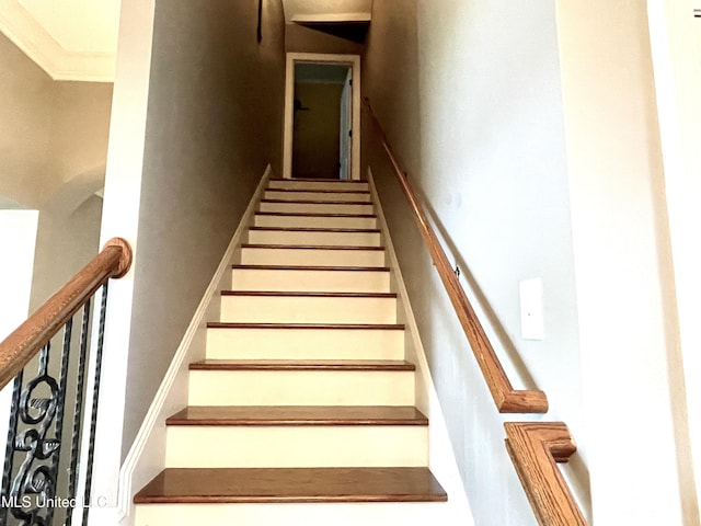 stairway featuring crown molding