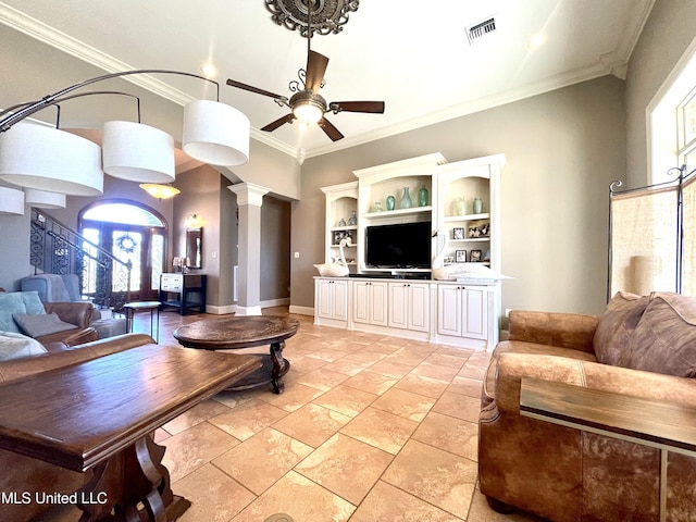 living room featuring decorative columns, ceiling fan, and crown molding