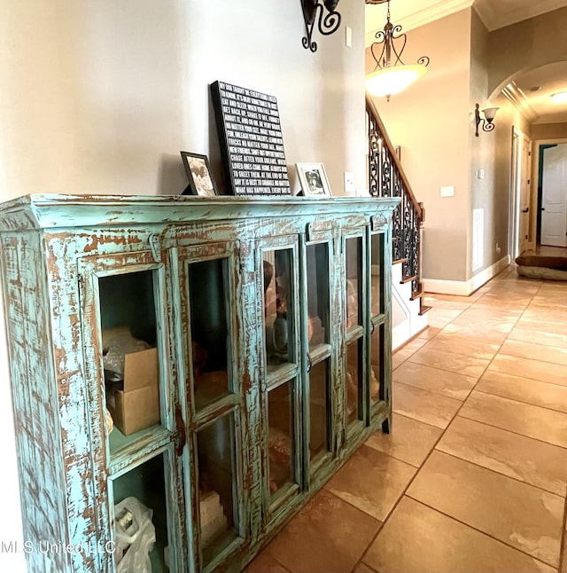 interior space with tile patterned flooring and ornamental molding