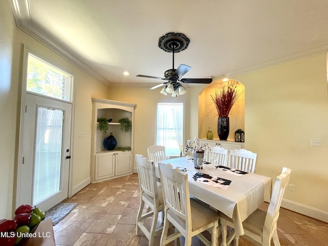 dining space featuring plenty of natural light, ornamental molding, and ceiling fan