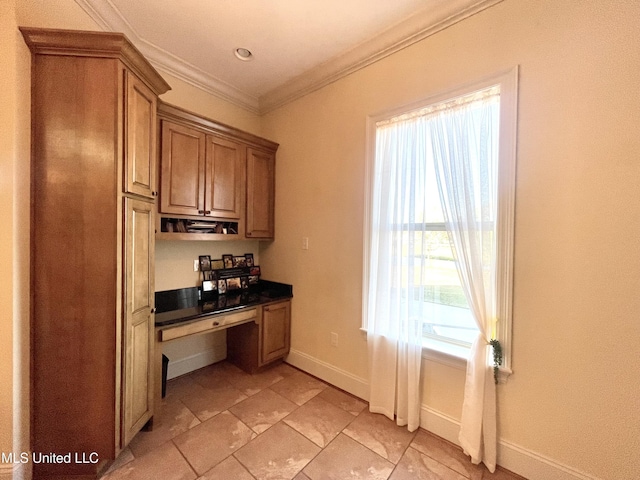 kitchen featuring built in desk and crown molding