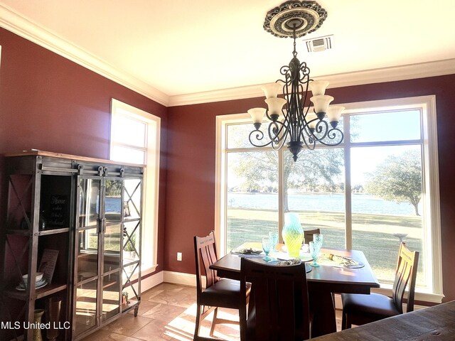 dining area with a water view, ornamental molding, and a chandelier