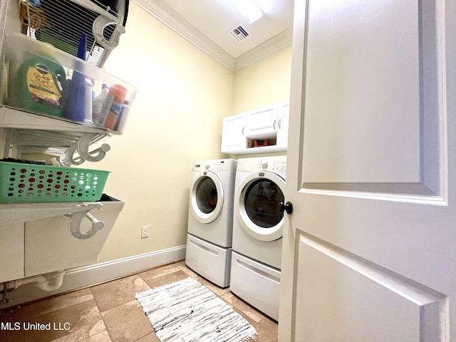 washroom featuring washer and dryer, cabinets, and ornamental molding