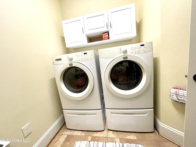 washroom with cabinets, light tile patterned flooring, and washer and dryer