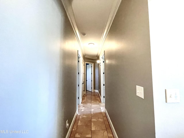 hallway featuring light tile patterned floors and ornamental molding