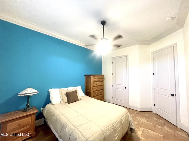 bedroom with ceiling fan and crown molding