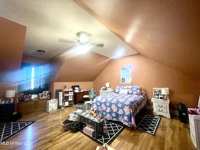 bedroom with hardwood / wood-style floors, vaulted ceiling, and ceiling fan