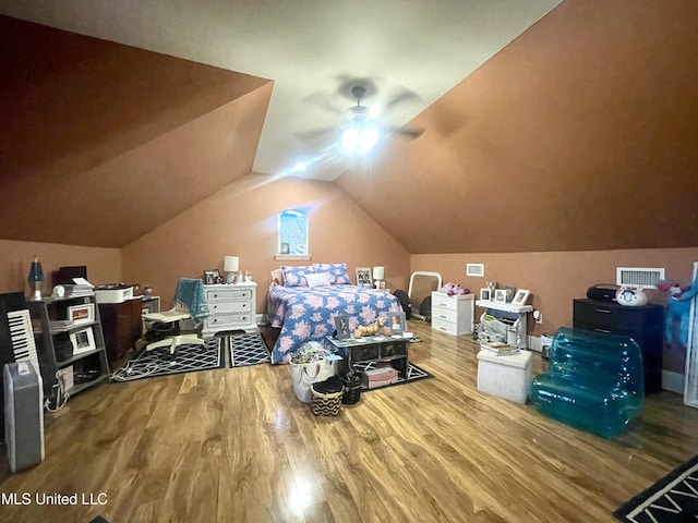 bedroom featuring ceiling fan, hardwood / wood-style floors, and lofted ceiling