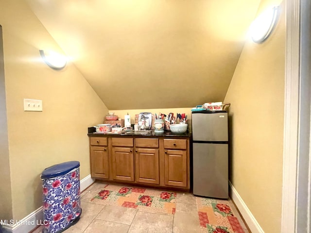 interior space with light tile patterned floors and sink