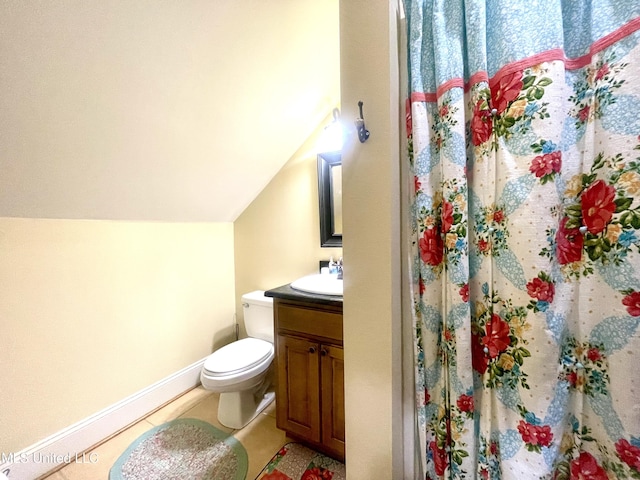 bathroom featuring vanity, vaulted ceiling, tile patterned flooring, toilet, and curtained shower