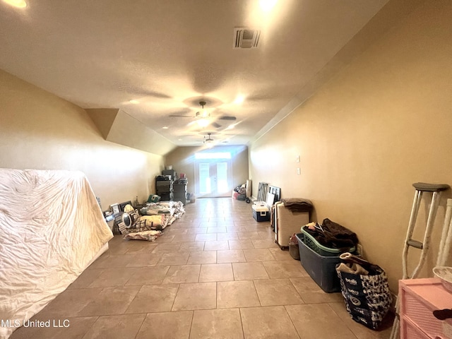 bonus room with ceiling fan, light tile patterned floors, and lofted ceiling