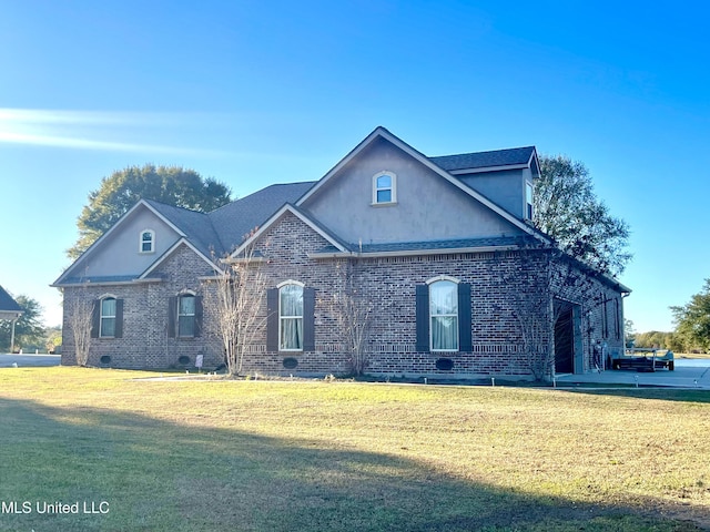 view of front of house with a garage and a front lawn