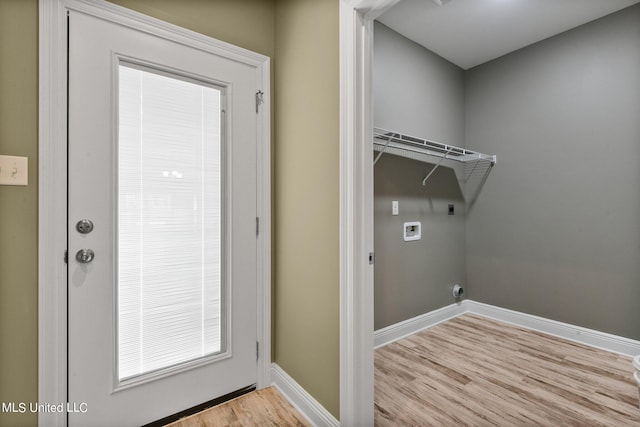 laundry room with electric dryer hookup, washer hookup, and light wood-type flooring