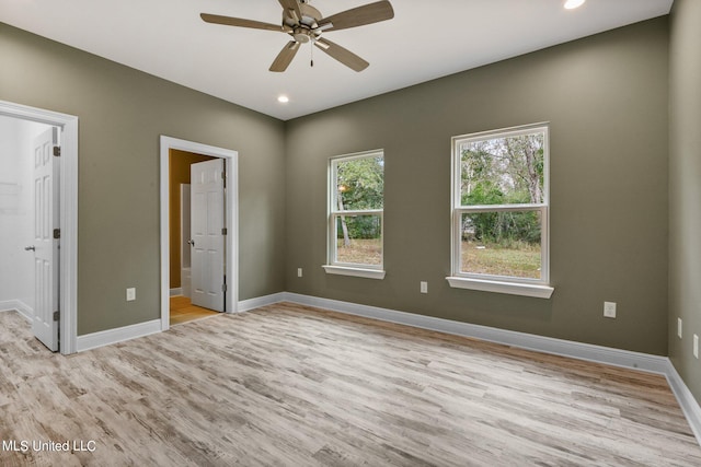 unfurnished bedroom with connected bathroom, light wood-type flooring, and ceiling fan