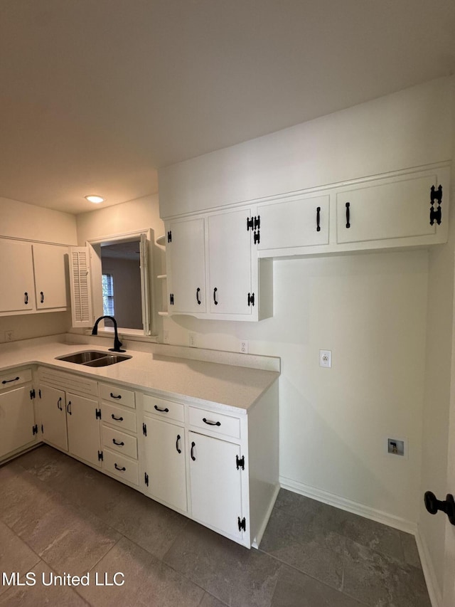 1597 Vicksburg Dr, Southaven, MS 38671 - kitchen with a sink, light countertops, white cabinets, and baseboards