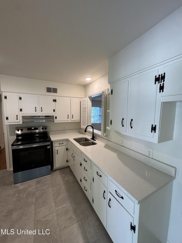 1597 Vicksburg Dr, Southaven, MS 38671 - kitchen featuring electric stove, a sink, under cabinet range hood, and white cabinetry