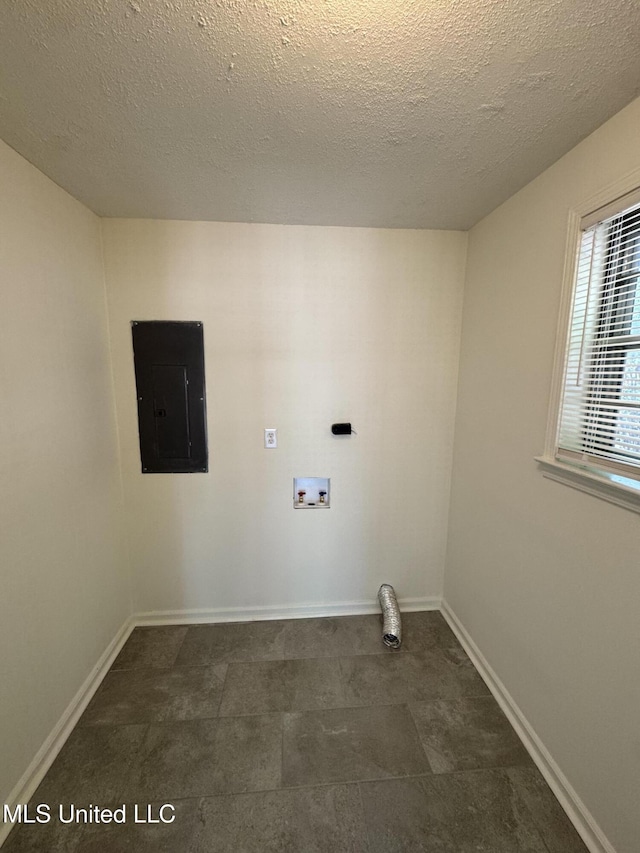 1597 Vicksburg Dr, Southaven, MS 38671 - laundry area with hookup for a washing machine, electric panel, baseboards, and a textured ceiling
