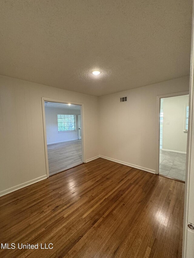 1597 Vicksburg Dr, Southaven, MS 38671 - empty room with a textured ceiling, wood finished floors, and baseboards