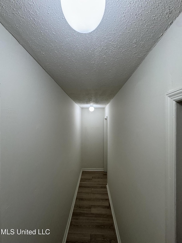 1597 Vicksburg Dr, Southaven, MS 38671 - hall featuring a textured ceiling, wood finished floors, and baseboards