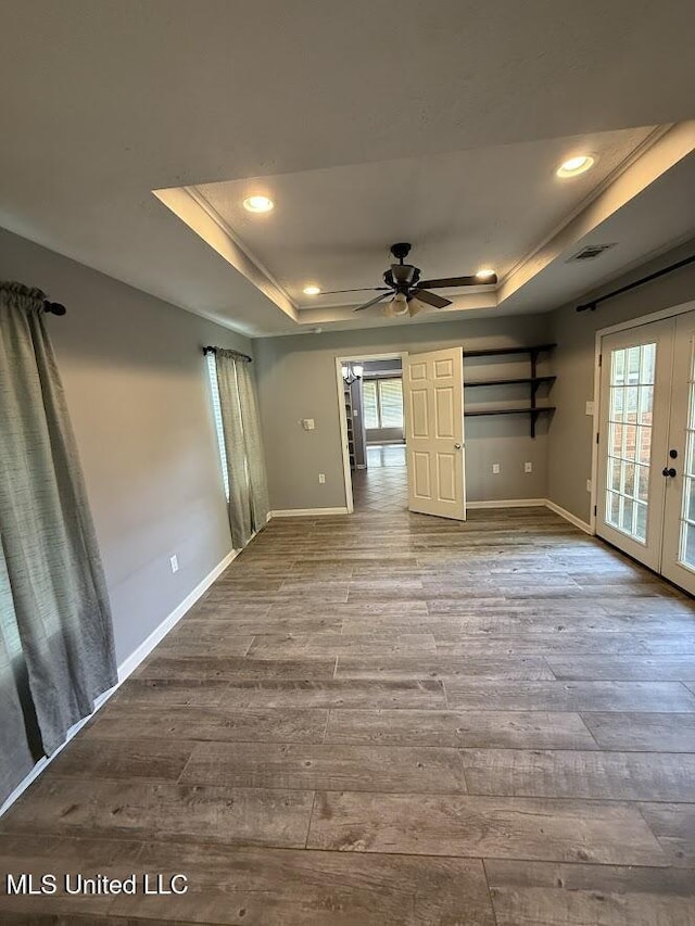 22090 Rayvan Ln, Kiln, MS 39556 - unfurnished living room featuring a raised ceiling, french doors, wood finished floors, ceiling fan, and recessed lighting
