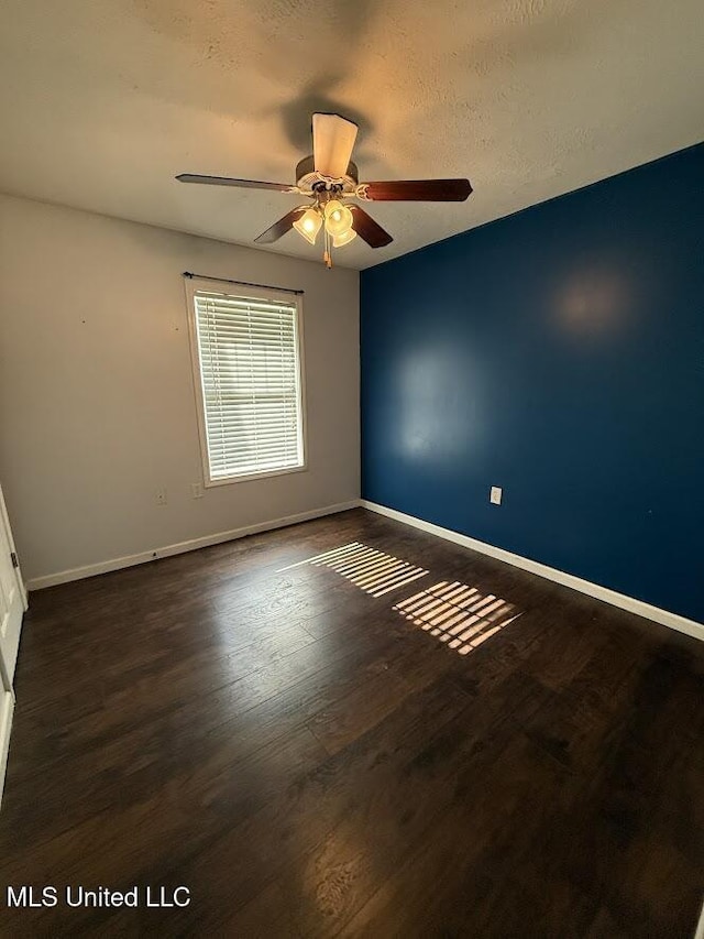22090 Rayvan Ln, Kiln, MS 39556 - spare room featuring ceiling fan and dark wood-style floors