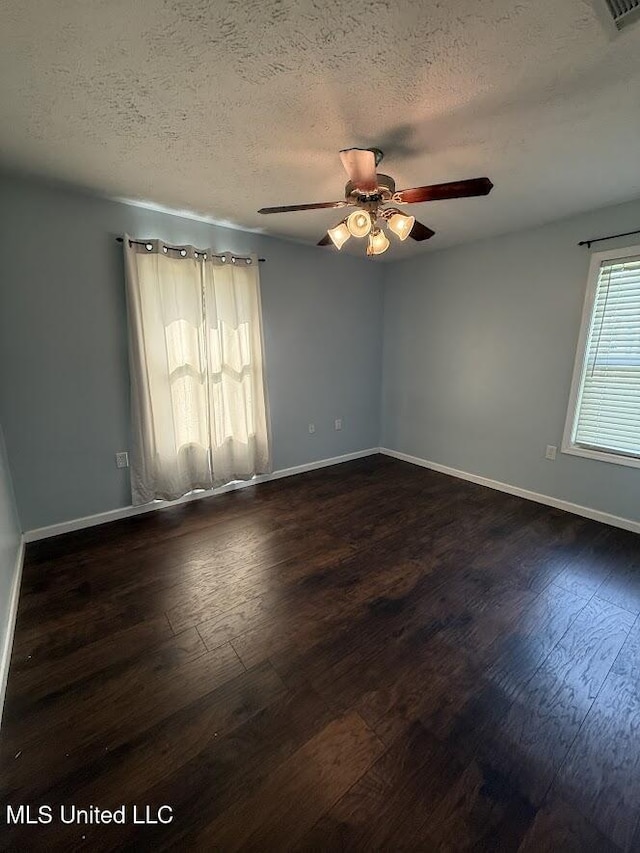 22090 Rayvan Ln, Kiln, MS 39556 - empty room featuring ceiling fan, dark wood-style flooring, and a textured ceiling