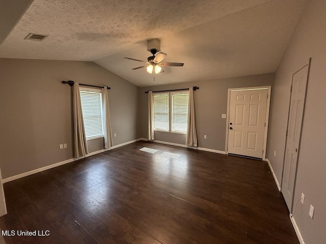 22090 Rayvan Ln, Kiln, MS 39556 - spare room with ceiling fan, dark wood-type flooring, lofted ceiling, and a textured ceiling