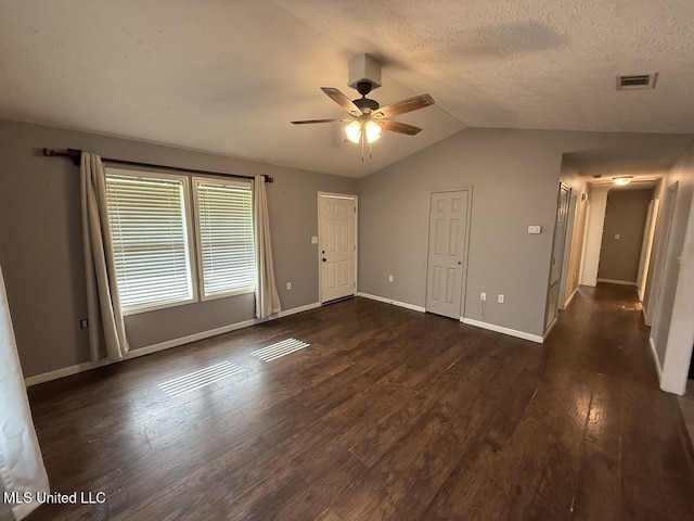 22090 Rayvan Ln, Kiln, MS 39556 - unfurnished living room featuring a ceiling fan, lofted ceiling, wood finished floors, and a textured ceiling