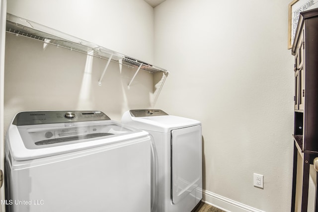 laundry area featuring washer and dryer, baseboards, and laundry area