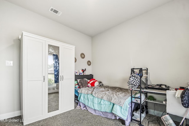 bedroom with visible vents and carpet flooring