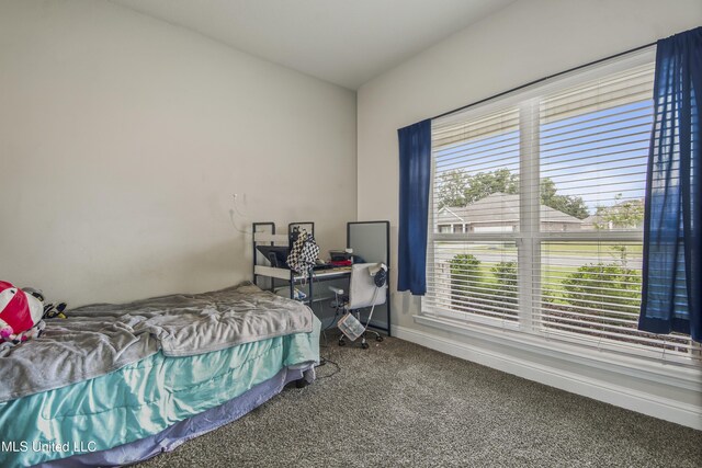 carpeted bedroom featuring baseboards