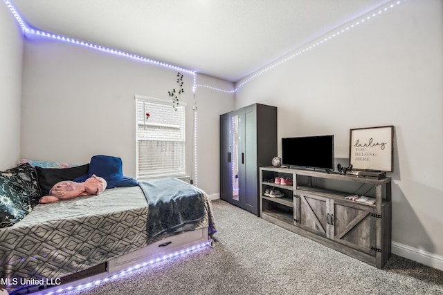 bedroom with carpet flooring and baseboards