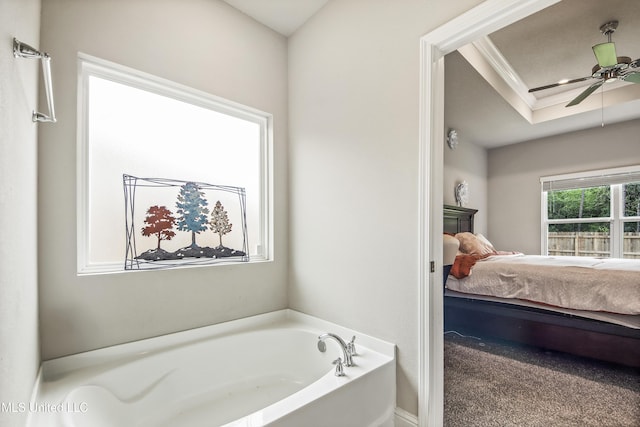 full bathroom featuring a tray ceiling, ceiling fan, crown molding, a bath, and connected bathroom