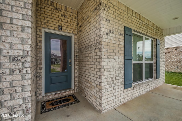 entrance to property with brick siding