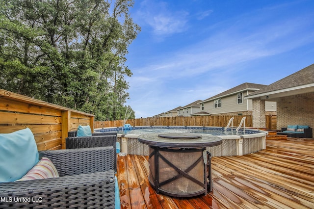 wooden terrace featuring a fenced in pool and a fenced backyard