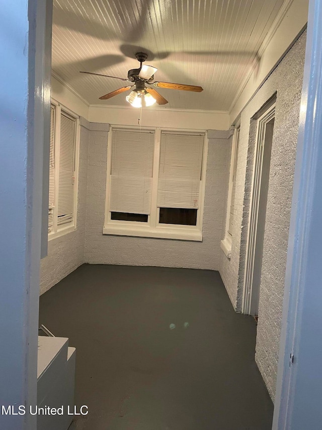 unfurnished room featuring ceiling fan and ornamental molding