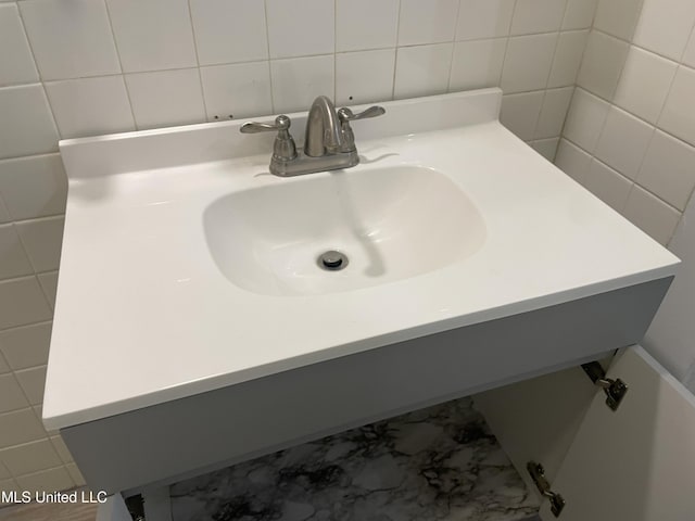 bathroom with vanity and tile walls