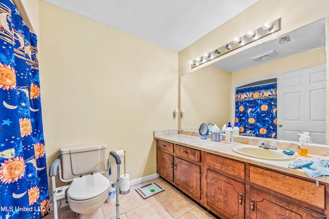 bathroom with vanity, tile patterned floors, and toilet