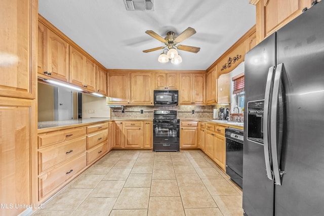 kitchen featuring light tile patterned floors, sink, ceiling fan, tasteful backsplash, and black appliances