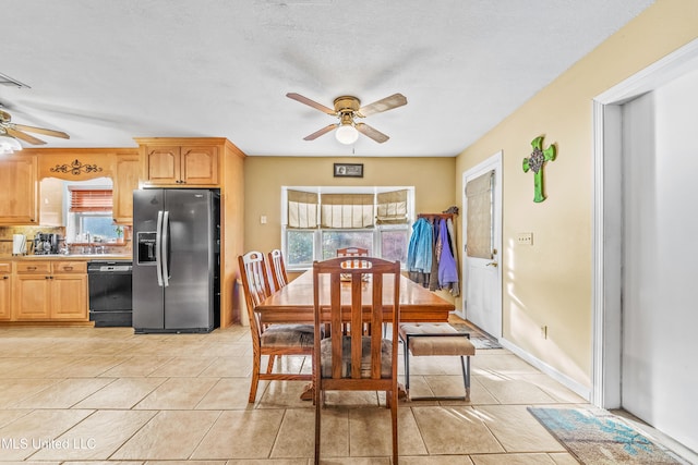 tiled dining room featuring ceiling fan