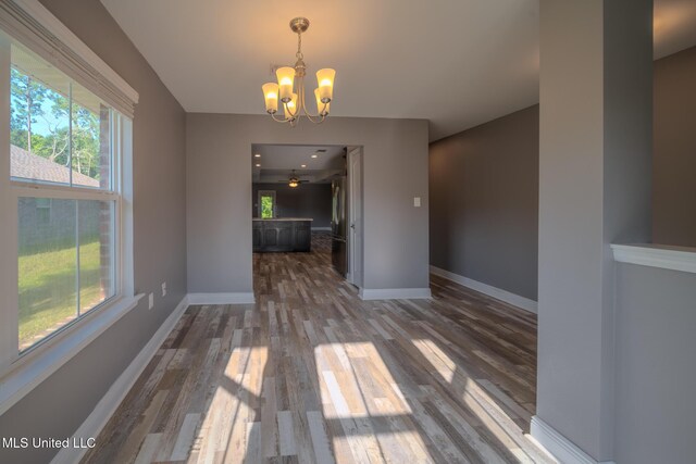 13724 Fox Hill Dr, Gulfport, MS 39503 - unfurnished dining area with a chandelier, dark wood-style floors, and baseboards
