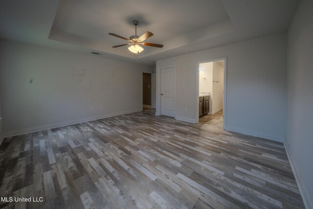 13724 Fox Hill Dr, Gulfport, MS 39503 - unfurnished room with a tray ceiling, wood finished floors, ceiling fan, and baseboards