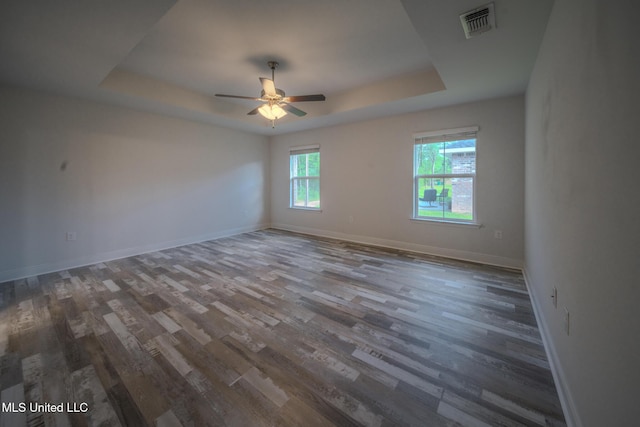 13724 Fox Hill Dr, Gulfport, MS 39503 - empty room featuring a raised ceiling, wood finished floors, ceiling fan, and baseboards